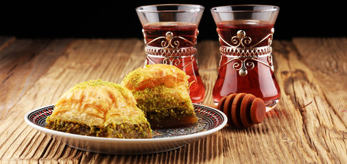 Turkish Dessert Baklava with pistachio on wooden table.