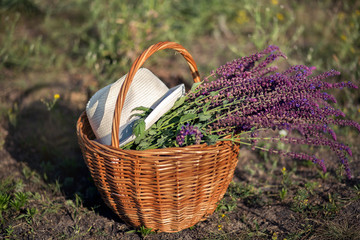 Fototapeta na wymiar Basket, wild flowers, hat