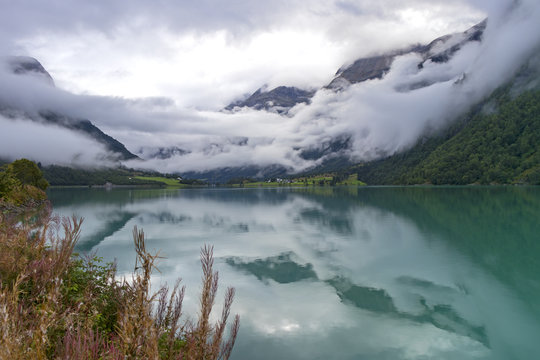 Idyllic Lake Oldevatnet with fog in the morning, Norway