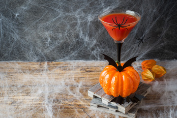 Bloody Mary cocktail, pumpkin with bats and spiders for Halloween, selective focus Copy space