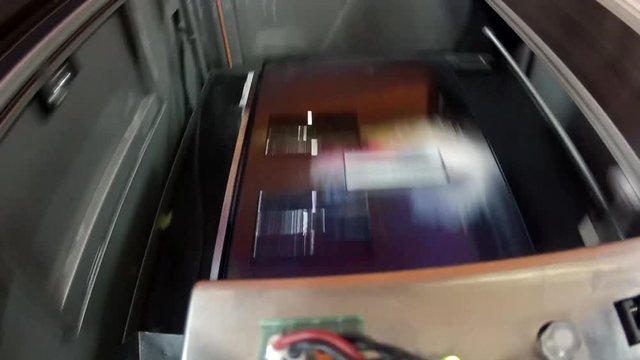 Video shooting of the industrial printer. Print a color banner on the adhesive film.