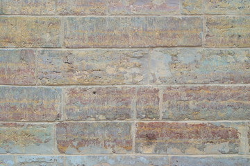 Fototapeta premium The image of old bright brick wall closeup.