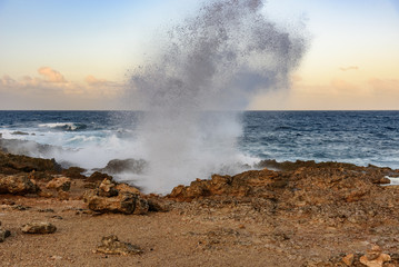 Waves break on the rocks