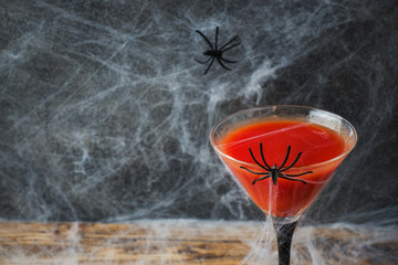 Bloody Mary cocktail, spider web background for Halloween, selective focus Copy space