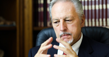 Portrait of a thoughtful manager in his office