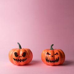 Halloween pumpkin on pastel pink background. Halloween minimal concept.