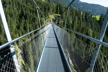 rope bridge over a deep canyon, tirol, austria