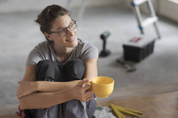 Woman doing a home renovation and having a coffee break