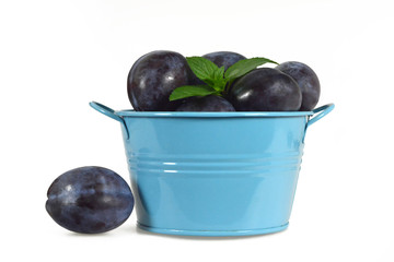 Plums in the bowl isolated on white background