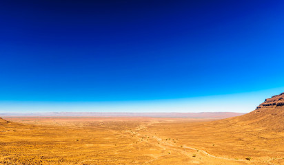 Fototapeta na wymiar Remote dry Hammada landscape by M'hamid in Morocco