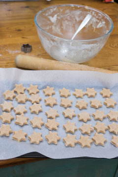 Messy Home Baking In Kitchen: Dirty Mixing Bowl, Rolling Pin, Cookie Cutter And Star Shaped Biscuit Dough Ready To Bake