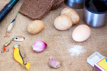 fisherman snack with fishing rod and baits on background