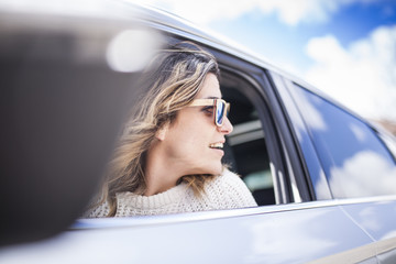 two women singing in the car