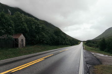 A Road in Norway heading between two hills.