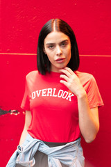 Portrait of brunette girl with overlook tshirt in red