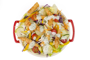 amazing salad with fried tilapia strips isolated in white background seen from above
