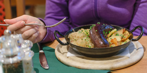 Traditional austrian dish blood sausage with sauerkraut and fries