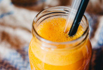 Fresh pumpkin juice with two straws close up