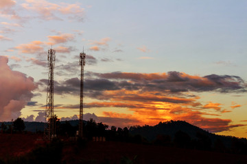 Telecommunication tower on top of the mountain whit colorful sky at sunset time.