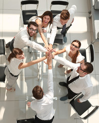 top view.the company's employees are giving each other high five