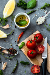 Ingredients to cook home made italian tomato sauce. spicy. dark background.