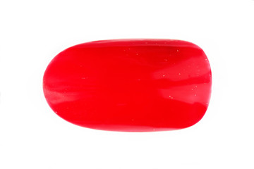 one plastic tip for nail extension and training in applying design while training a manicure on a white background, isolated. trial student work. monophonic red lacquer shellac.