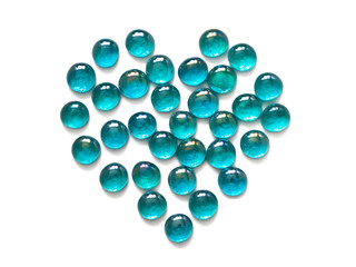 Heart lined with glass decorative stones, turquoise isolated on white background. Top view