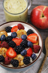 Useful breakfast of cottage cheese, sour cream and various berries with fruits on the dining table