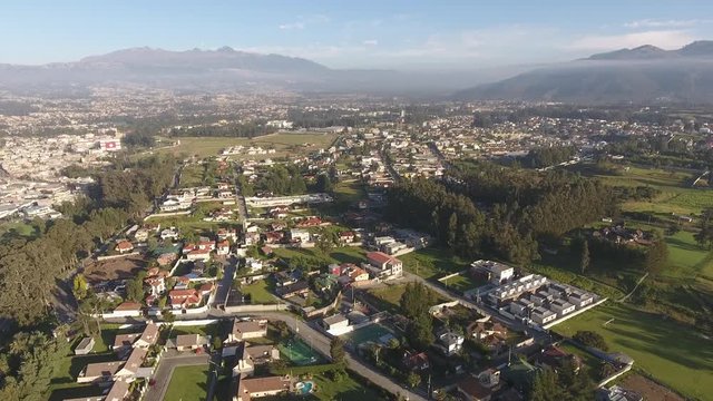 Aerial view of Sangolqui, Ecuador. In the Inter-Andean valley near Quito, Ecuador. With the Santa Clara Ravine. The football stadium is visible left. Pan to Ilalo Mountain.