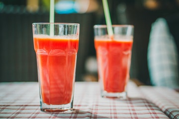 glass with tomato juice and a straw