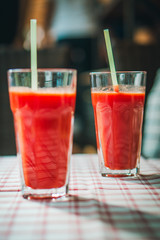 glass with tomato juice and a straw