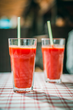 glass with tomato juice and a straw