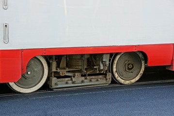 gray iron wheels and part of the tram on rails