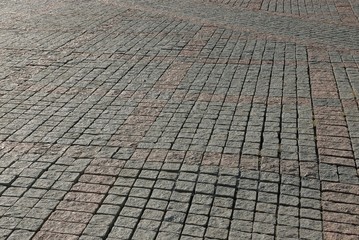 gray brown stone texture of paving tiles on the road