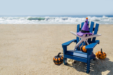 Fototapeta na wymiar Halloween background on the beach with starfishes in witch's hats