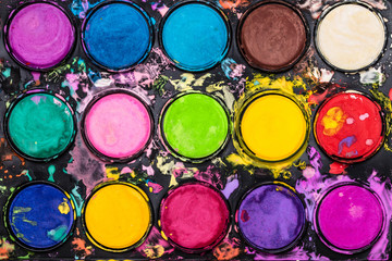 Watercolor paint palette. Colorful paint splash.