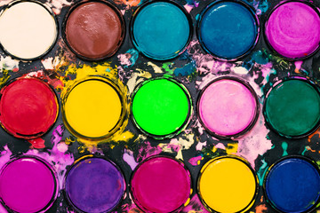 Watercolor paint palette. Colorful paint splash.