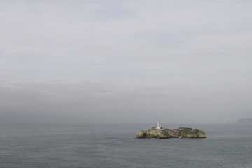 Panoramic view of Mouro Island and lighthouse in Santander, Spain