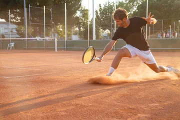 Poster Im Rahmen Professional tennis player man playing on court in afternoon. © pablobenii
