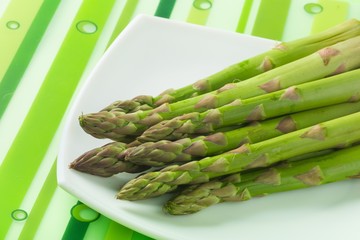 Asparagus on the Plate on Green Background