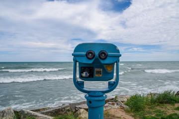 Blue coin operated binoculars for viewing the beautiful blue sea