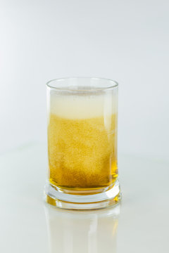 Beer with foam and bubbles on a white background