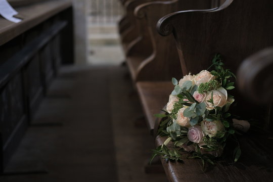 Bouquet of roses on a bench in a church