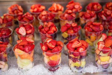 Fruit for sale in plastic cups stored on crushed ice in Rome Italy