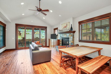 Adorable living room interior with stone fireplace.