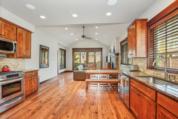 Wooden kitchen room with stone backsplash.