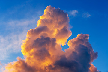 Orange cumulus clouds in sunrise with blue sky, sky burst