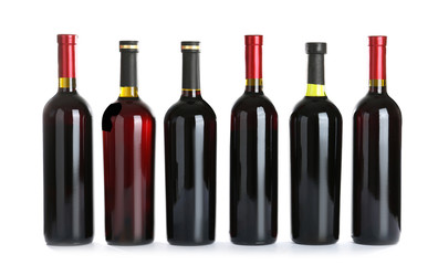 Bottles with red wine on white background