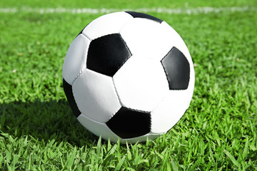 Fototapeta na wymiar Soccer ball on fresh green football field grass