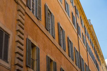 Fototapeta na wymiar Typical shuttered windows on a building in Rome, Italy